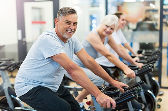 Man smiling while cycling with friends