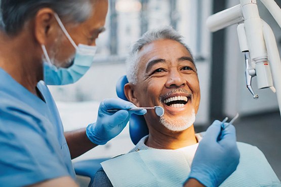 Man smiling during dental cleaning