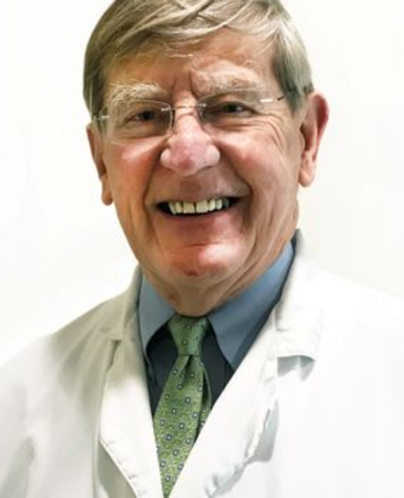 Worcester dentist Doctor Jacob Donohue smiling in white lab coat