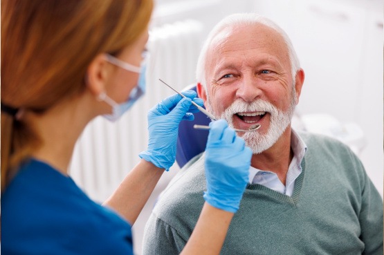 Mature man smiling during dental checkup 