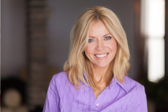 Mature woman in purple shirt smiling