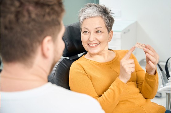 A woman chatting with her dentist