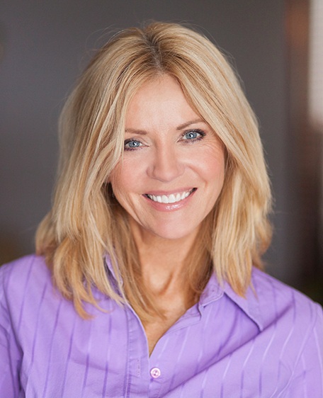 Woman in purple shirt smiling