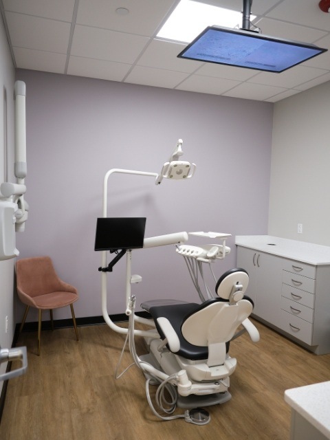 Dental scanning device standing against white wall