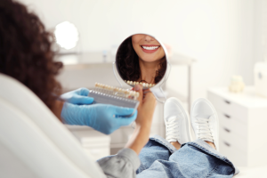 a person admiring their smile in a handheld mirror